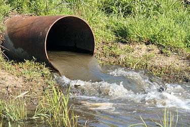 Wastewater discharge from a large pipe.